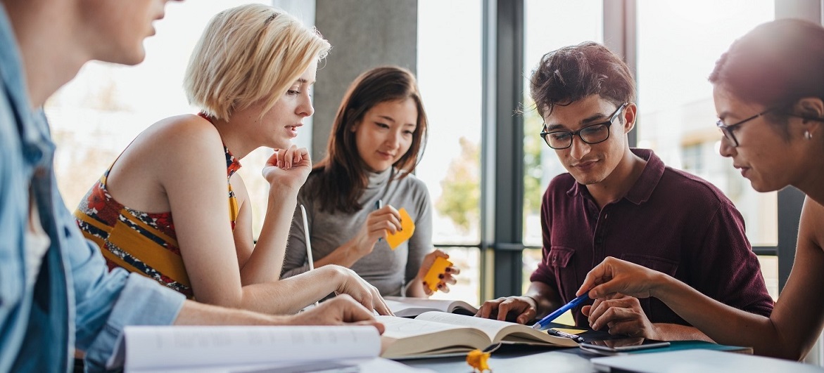 Diverse group of students studying at library